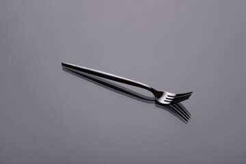 Cutlery on a gray background with shadow. Table serving