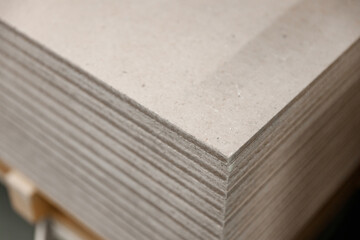 Drywall sheets folded in a bundle. Concept of renovation and construction