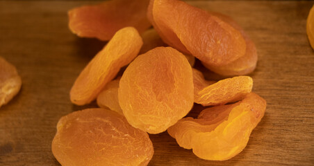Orange dried apricots. Dried apricot, dried fruits are scattered on the table.dietary dessert. Eco...