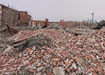 Abandoned, destroyed factory building with pile of bricks