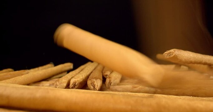Italian breadsticks falling on black surface close up. Italian food concept. Salty Breadstick Crackers. High quality. 