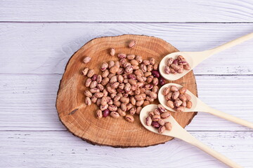 Natural bean grains, Phaseolus vulgaris on wooden background with light veins
