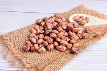 Natural bean grains, Phaseolus vulgaris on wooden background with light veins