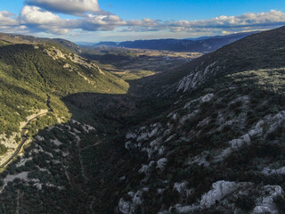 landscape with clouds, valley with rocks and shades, wind turbines
