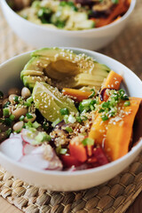 Homemade vegetarian poke bowl on the table. Atmospheric film grain color correction.