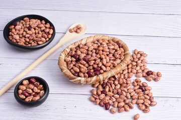 Natural bean grains, Phaseolus vulgaris on wooden background with light veins