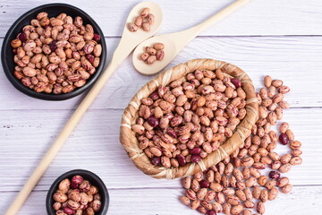 Natural bean grains, Phaseolus vulgaris on wooden background with light veins