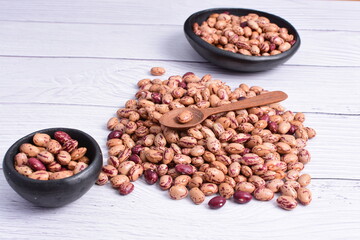 Natural bean grains, Phaseolus vulgaris on wooden background with light veins