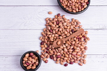 Natural bean grains, Phaseolus vulgaris on wooden background with light veins