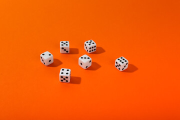dice on orange background top view with copy space. 
