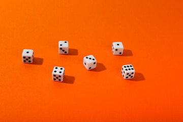 dice on orange background top view with copy space. 