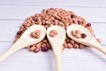 Natural bean grains, Phaseolus vulgaris on wooden background with light veins