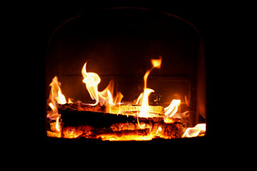 Burning hot logs in an open metal fireplace, flame, open fire