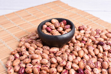 Natural bean grains, Phaseolus vulgaris on wooden background with light veins