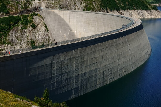 Hydroelectric Power Plant With A Huge Dam And Little People On It