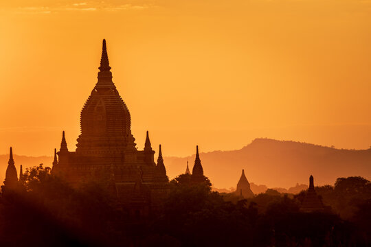 SUNSET, TEMPLES OF BAGAN, MYANMAR - 26 November 2019: Silhouette of iconic Bagan temple shape at sunset.