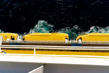 lifeboats on a ship at sea at night, top view