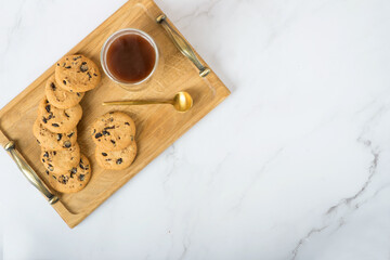 cookies and coffee on a tray on a white table. space for text