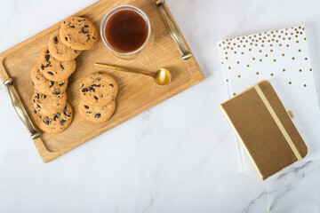 Cup of coffee, notebook and rose flowers. Vintage. Flat lay, top view.