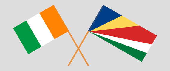 Crossed flags of Republic of Ivory Coast and Seychelles