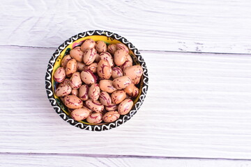 Natural bean grains, Phaseolus vulgaris on wooden background with light veins