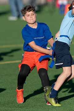 Young boy playing flag football