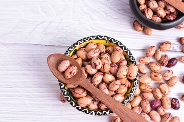 Natural bean grains, Phaseolus vulgaris on wooden background with light veins