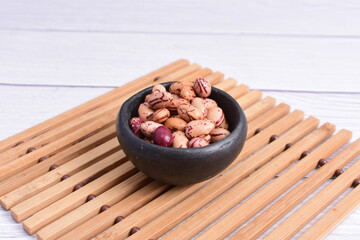 Natural bean grains, Phaseolus vulgaris on wooden background with light veins