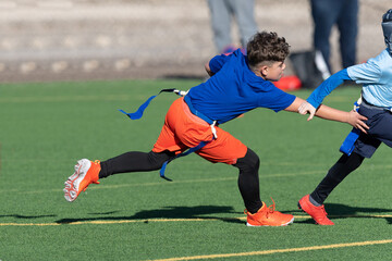 Young boy playing flag football