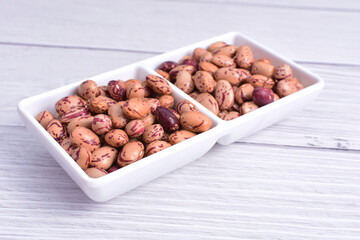 Natural bean grains, Phaseolus vulgaris on wooden background with light veins