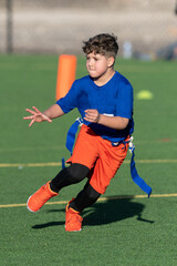 Young boy playing flag football