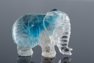 beautiful statuette elephant from the mineral topaz on a gray background
