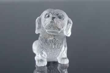beautiful statuette of a dog from the mineral topaz on a gray background