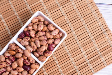 Natural bean grains, Phaseolus vulgaris on wooden background with light veins