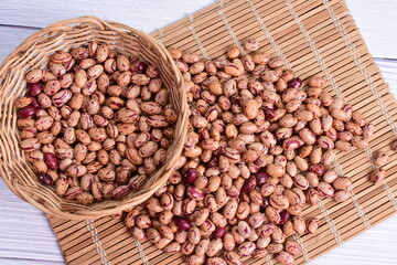 Natural bean grains, Phaseolus vulgaris on wooden background with light veins
