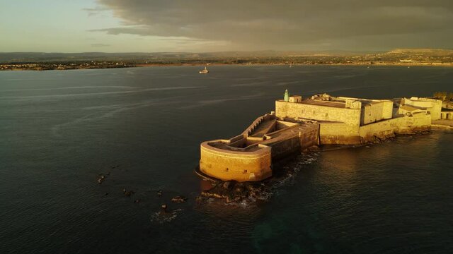 Castle Maniace from the top at early sunrise in Ortigia (Ortygia) island in Siracusa (Syracuse) in Sicily, Italy. Aerial view of the lighthouse of the Maniace castle 