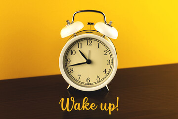 Retro alarm clock, wake up concept on a wooden table