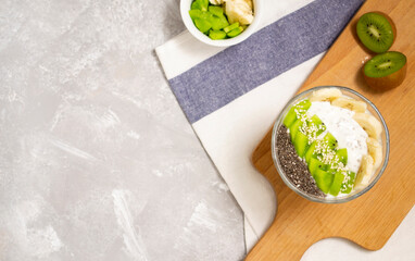 Chia pudding with kiwi, banana and different seeds. Healthy food concept.