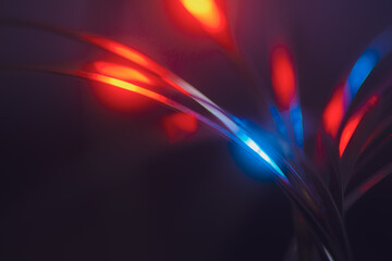 futuristic blurry abstract background in blue and red cinematic tones. strings, strips of arcs and with light highlights.
