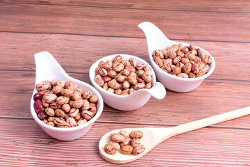 Natural bean grains
Phaseolus vulgaris on dark grain wood background