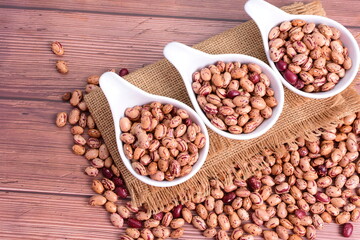 Natural bean grains
Phaseolus vulgaris on dark grain wood background