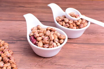 Natural bean grains
Phaseolus vulgaris on dark grain wood background