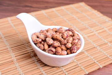 Natural bean grains
Phaseolus vulgaris on dark grain wood background