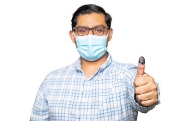 Man with mask happy casting his vote