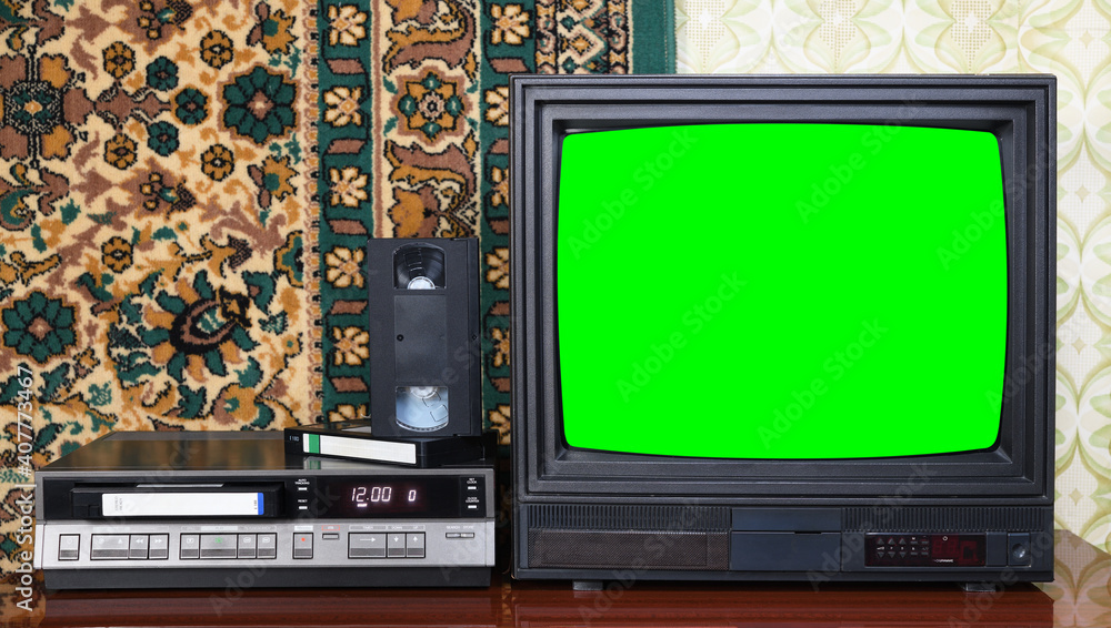 Wall mural old black vintage tv with green screen to add new images to the screen, vcr on wallpaper background.