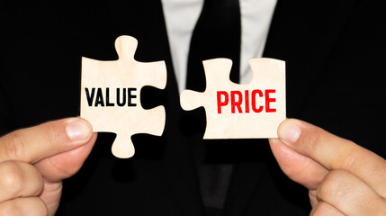 Value and price words written on two pieces of jigsaw puzzle.