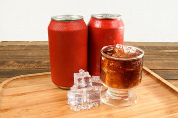 tray with aluminum soda can and glass filled with ice