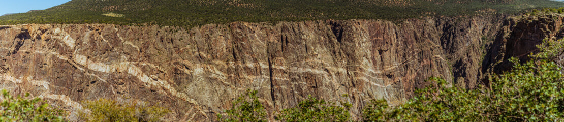 Panorama shot of rocky painted wall in black canyon of gunnisonin america