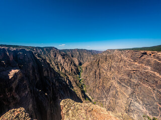 Portrait shot of gunnison river and rocky walls in black canyon of gunnison at sunny day in america