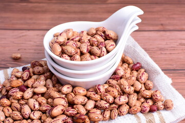 Natural bean grains
Phaseolus vulgaris on dark grain wood background